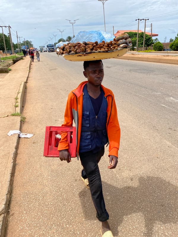 Afternoon foot traffic and street commerce in Bukuru, Nigeria
