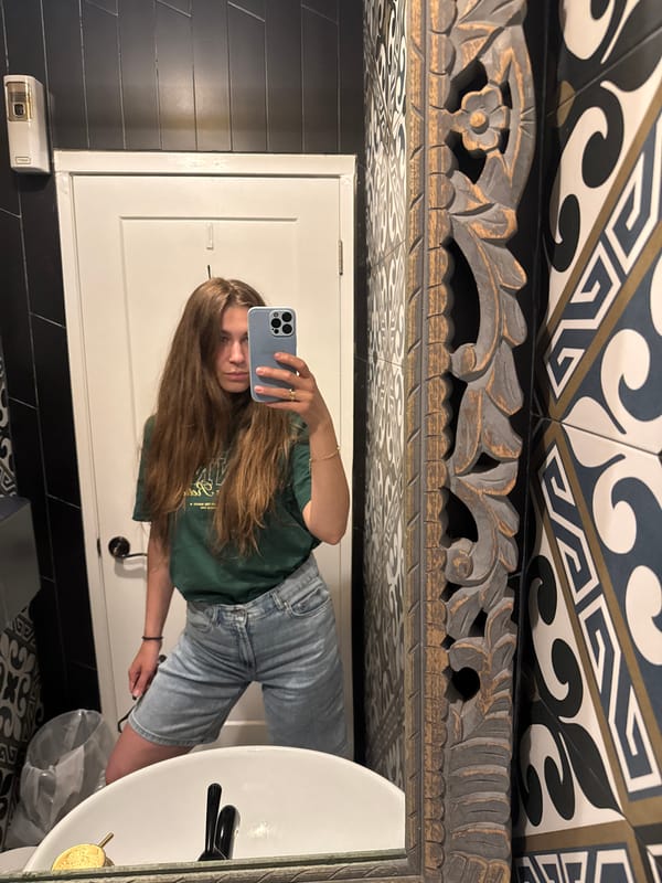 Woman documents Chinatown visit with selfies, archway photos