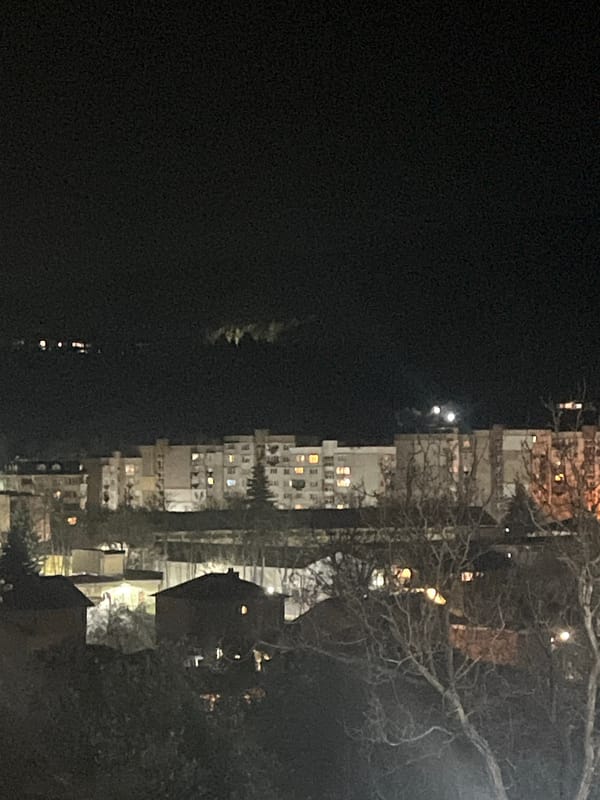 Illuminated apartment building observed at night in Pernik, Bulgaria