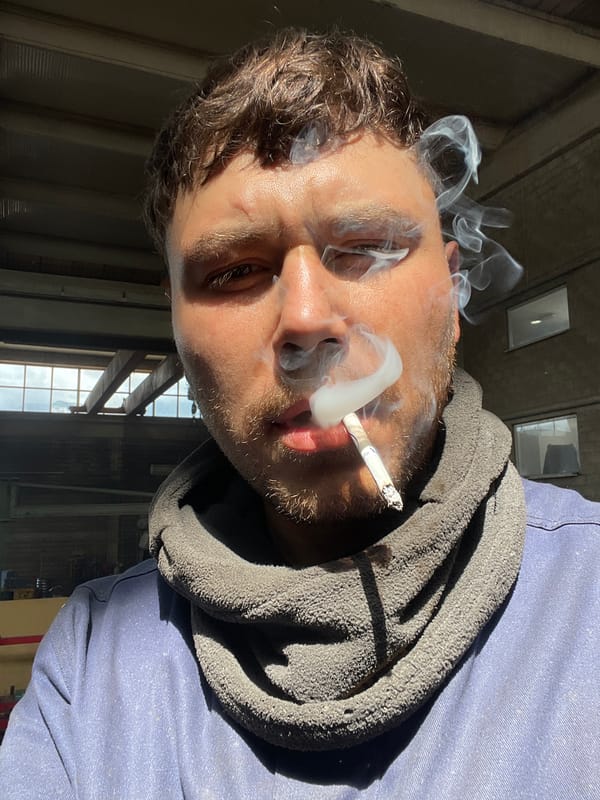 Worker Takes Cigarette Break in Zaljevo, Montenegro