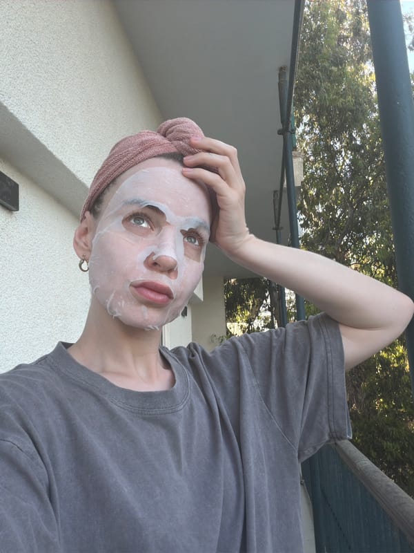 Woman poses for skincare photo in Tel Aviv neighborhood