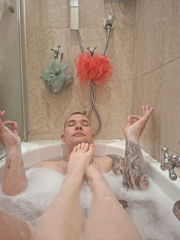 Unusual bathroom scene involving two tattooed individuals in Milan