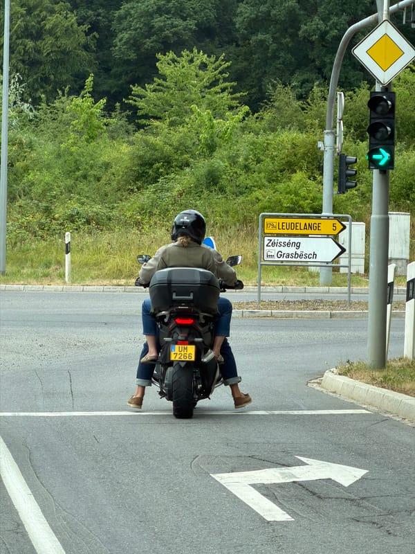 Motorcyclist paused at a green right-turn light in Luxembourg