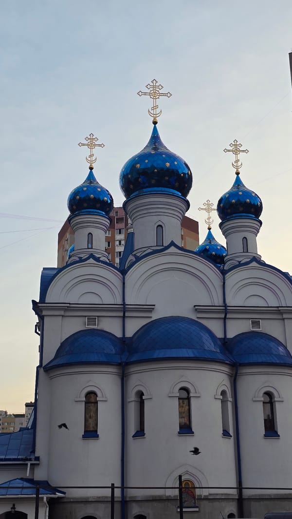 Orthodox church and urban lakeside scenes in a post-Soviet city