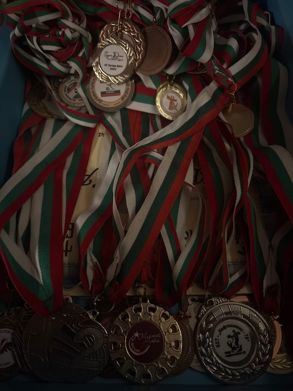 Trophies, medals, and floodlit urban sports fields at night