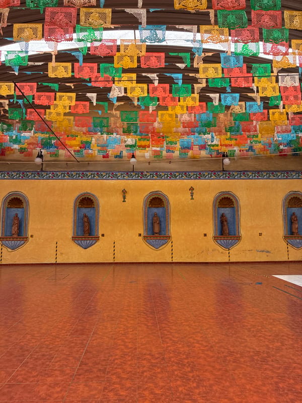 Traditional papel picado decorations spotted on Puebla building facade