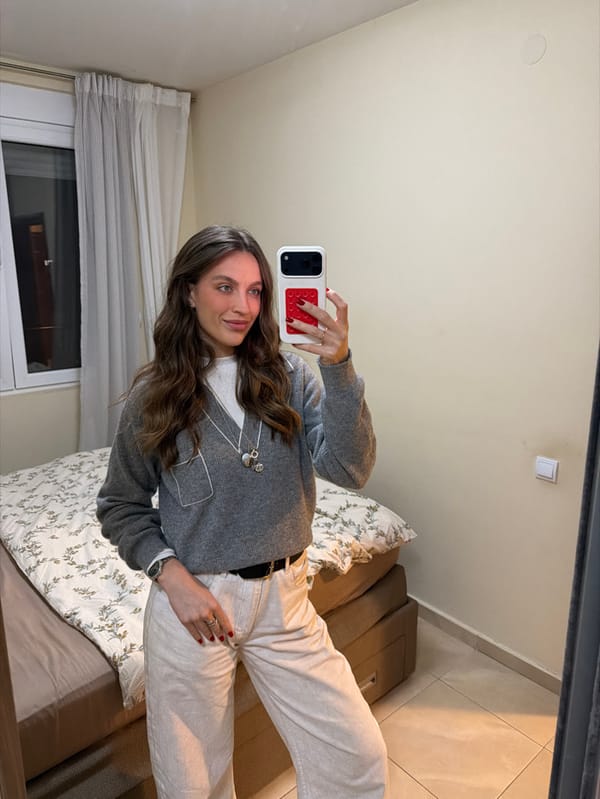 Woman takes selfies, relaxes indoors in Budva with dog