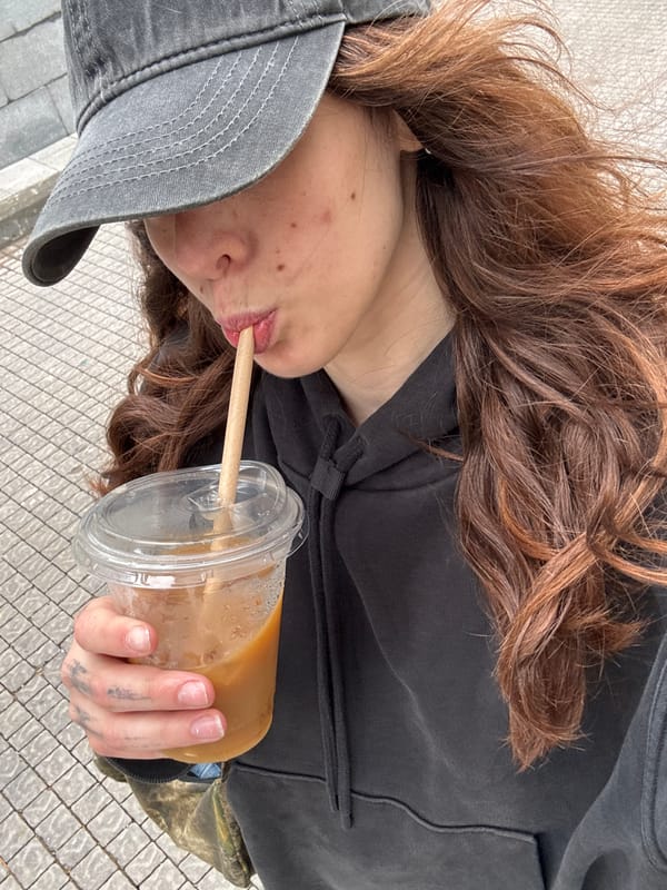 Woman drinks and takes photos simultaneously in Givatayim