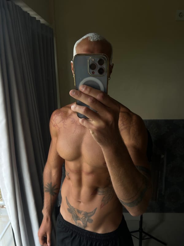 Mirror selfie session showing tattoos and physique in North Kuta
