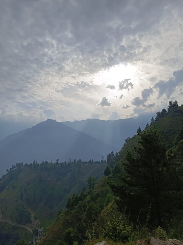 Cloudy skies and green valleys in Damadi's mountain terrain