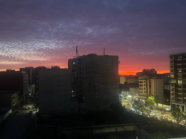 Twilight colors paint dramatic sky over Meknes cityscape