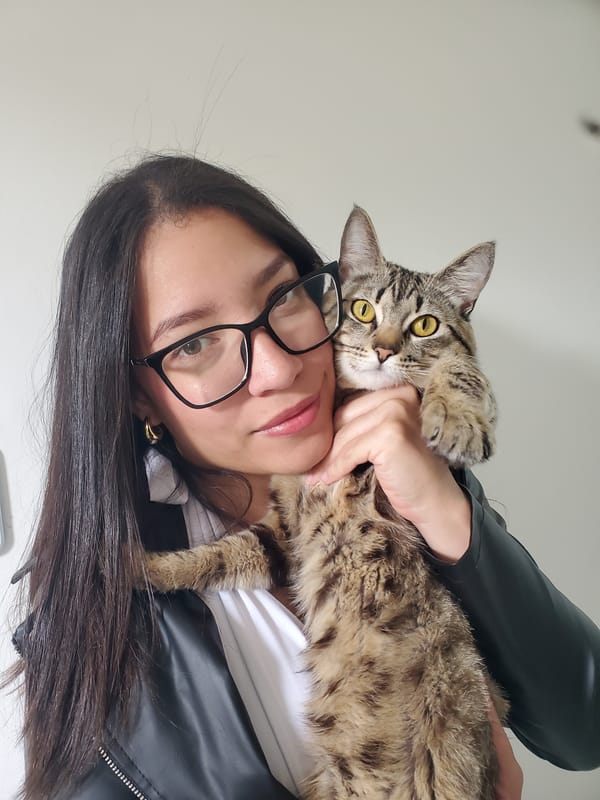 Woman poses with tabby cat in Curitiba