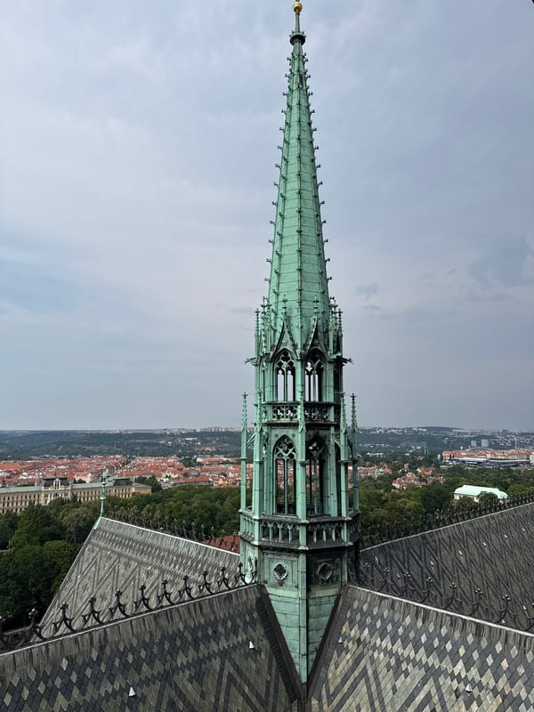 Gothic spire and rooftops rise above Prague