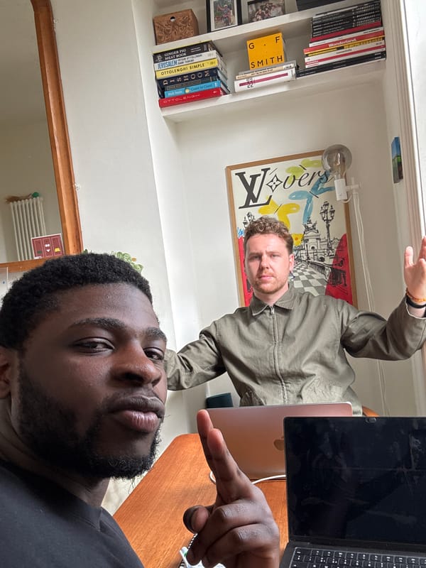 Two men captured in London indoor setting with office furniture