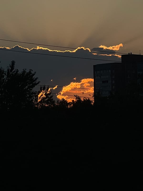 Saint Petersburg sunset through pylons, rooftops, and fading light
