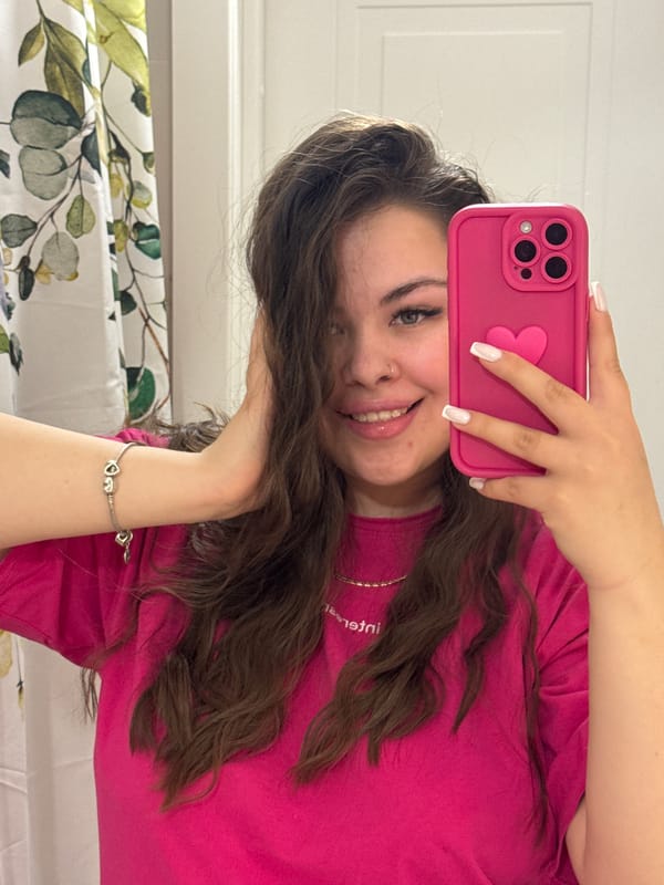 Woman takes mirror selfies with pink phone in Russia