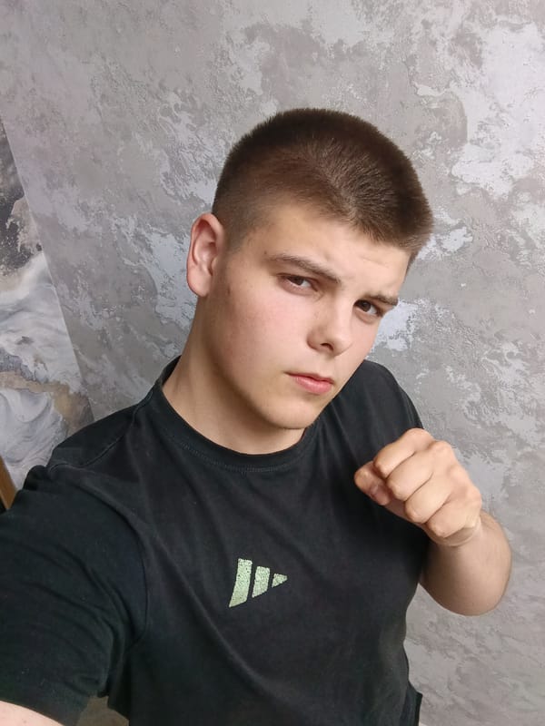 Young man poses with objects during indoor photo session