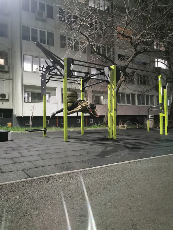 Man exercises on outdoor gym equipment in Burgas at night
