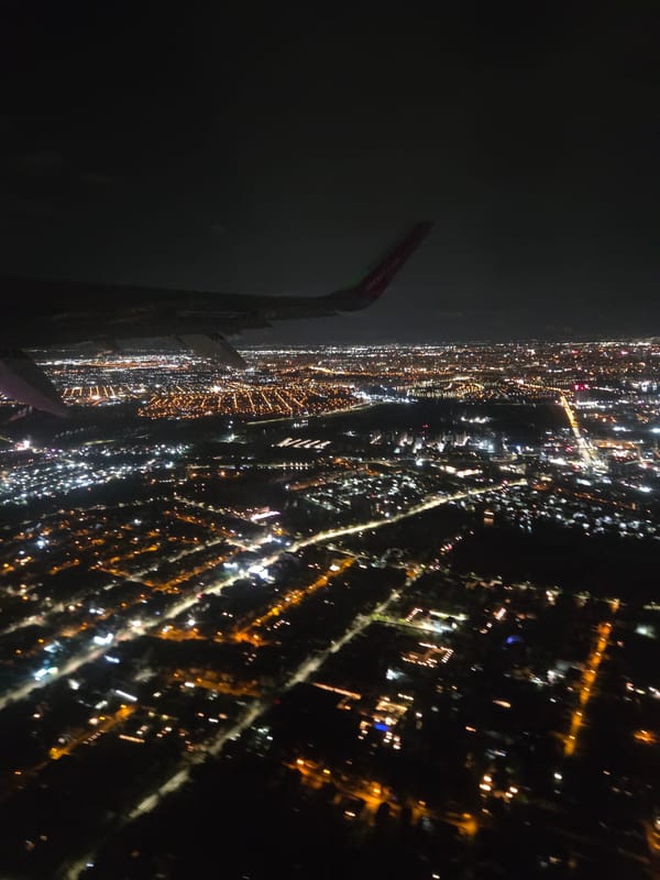Nighttime aerial view captures illuminated Voluntari cityscape