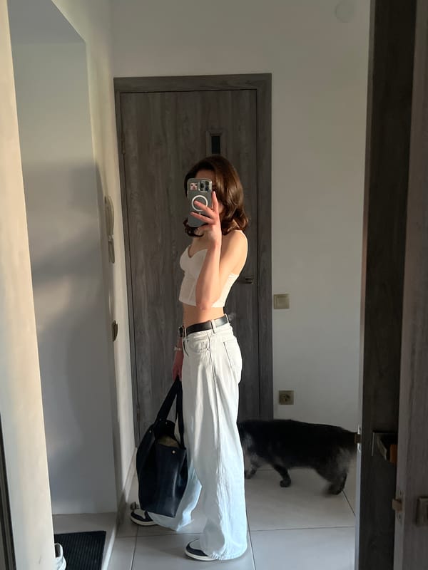 Woman takes mirror selfies with pink peonies in Ternopil