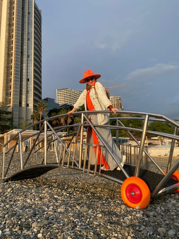 Tourist in orange outfit explores Sochi beachfront attractions