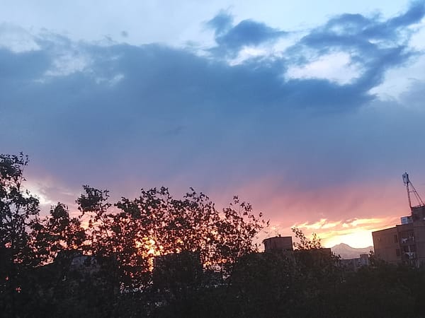 Urban courtyard badminton game documented during colorful sunset