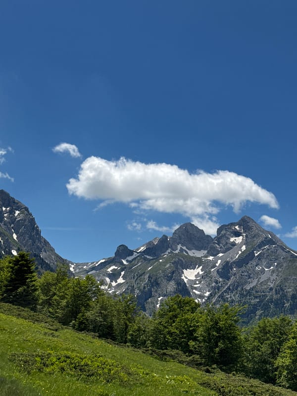 Mountain landscape with dirt road observed under clear skies