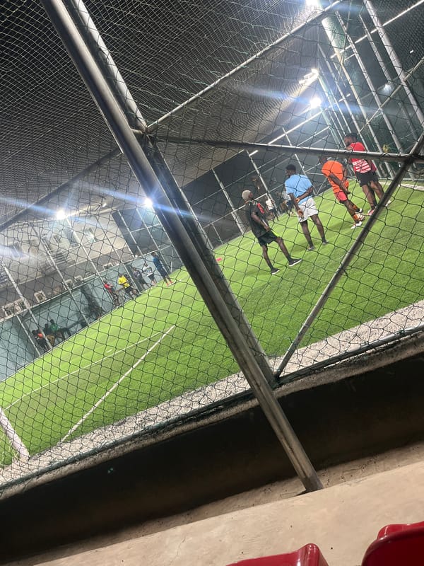 Evening soccer game observed at enclosed artificial turf facility
