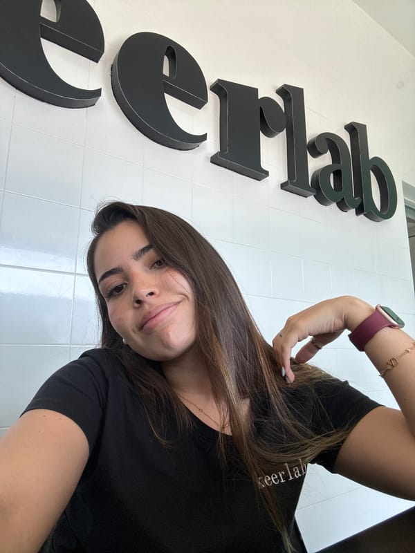 Woman takes selfie against lettered wall in Mexico