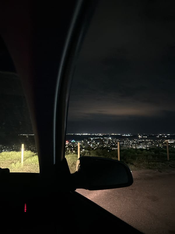 Motorist pauses roadside in Silistra, observes distant city lights