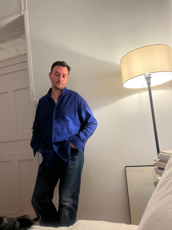 Man stands with eyes closed in Madrid room