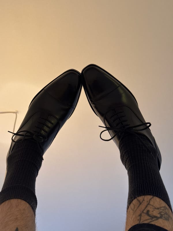 Black Oxford shoes photographed from above in Paris