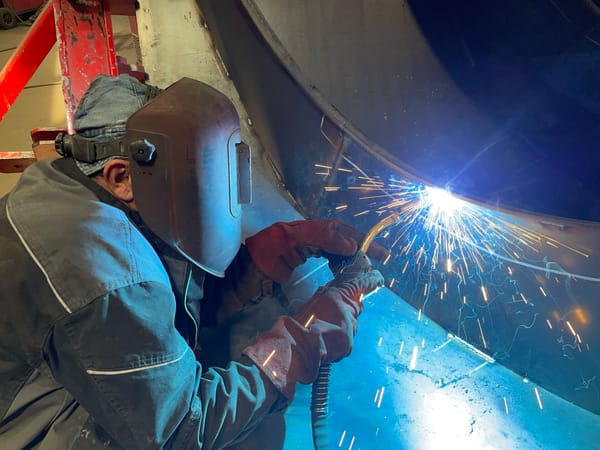 Welder works on metal structure in Tomba, Montenegro