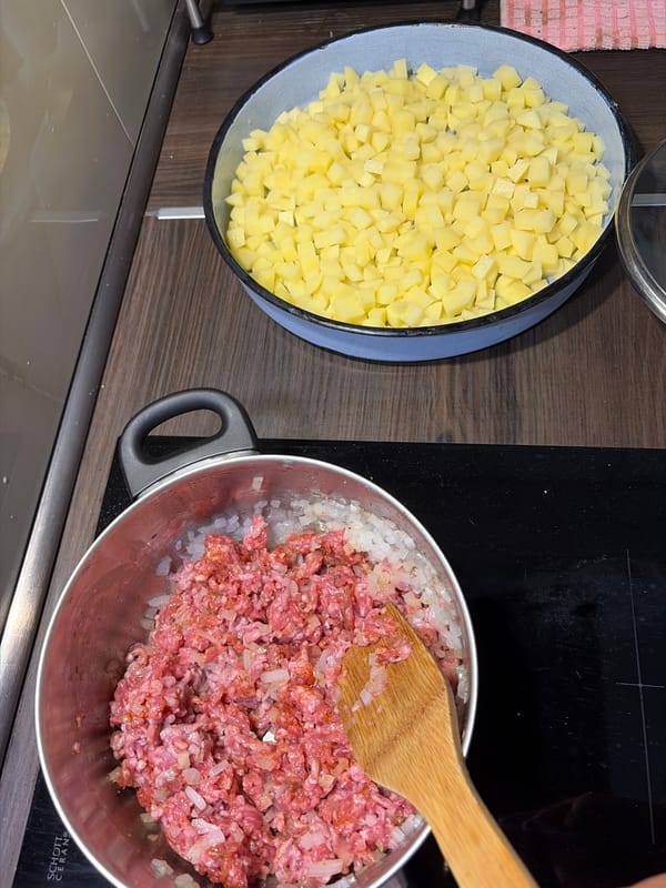 Ground meat and onions prepped in a pot on the stovetop