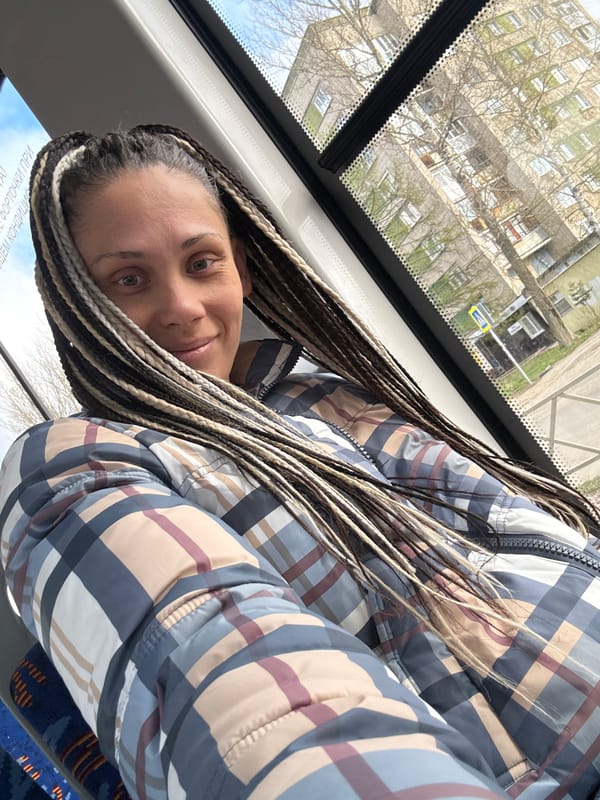 Woman with braids rides public transport in Rusanovo