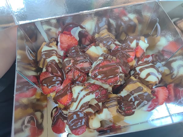 Waffles, strawberries, and roses in close-up detail shots
