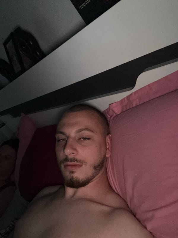 Man and dog rest in bedroom in Bulgaria