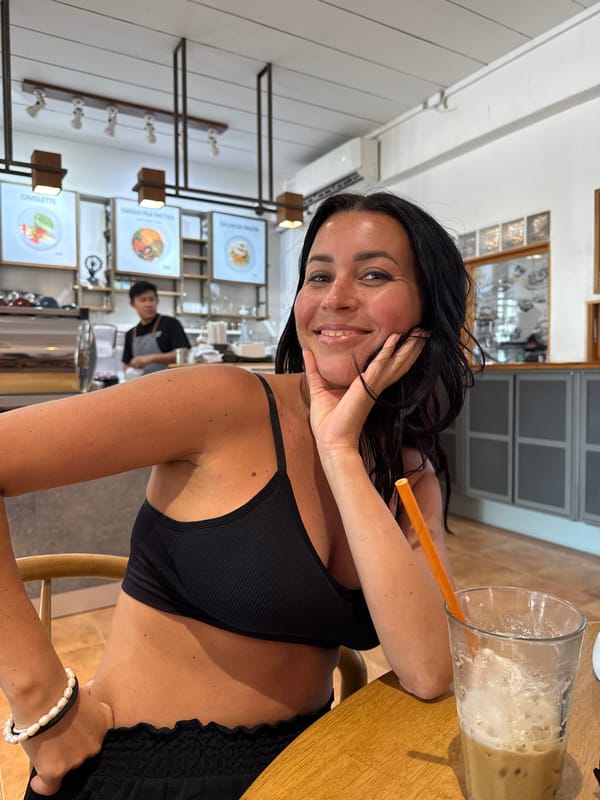 Woman photographed smiling at cafe table in Thong Sala