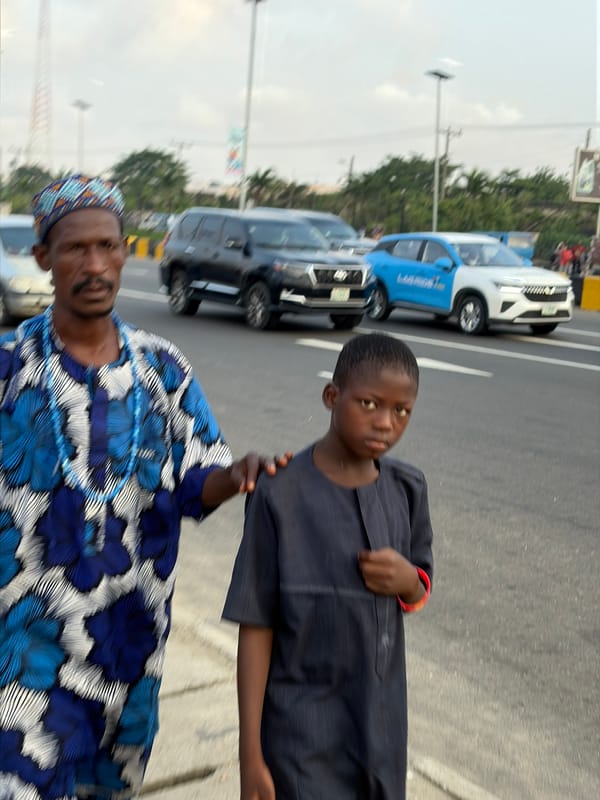 Two people on a paved road in Igboefon, Nigeria