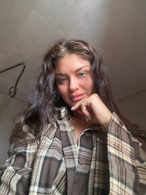 Woman takes selfie in plaid flannel shirt