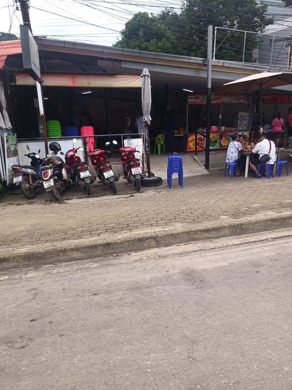 Motorbikes parked at roadside eatery in Ban Ao Nang