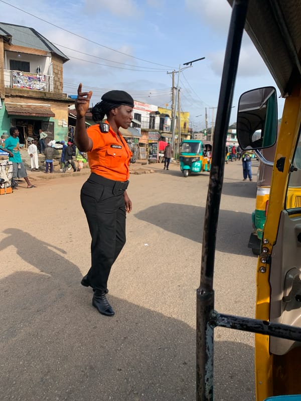 Traffic control and keke napep on a Gwong, Nigeria street