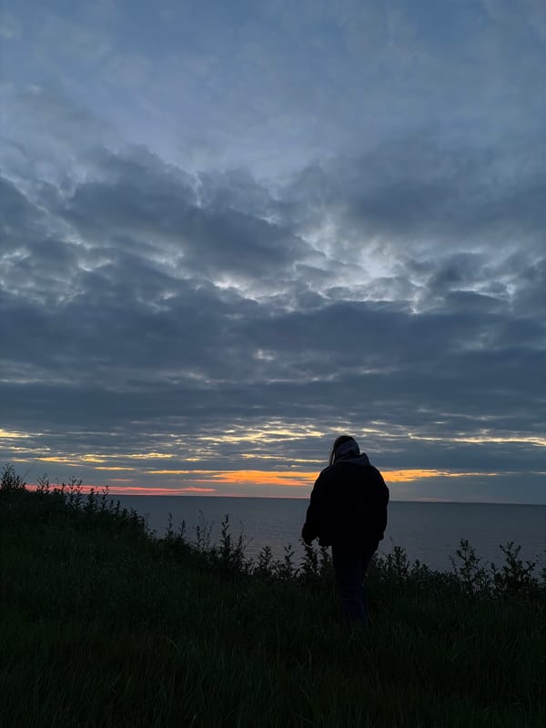 Figure silhouetted against dramatic sky in Port-Katon, Russia