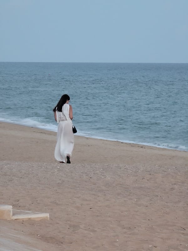 Quarteira beachfront at dusk: promenade life, street performance, summer evening