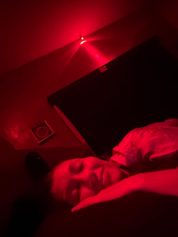 Red-lit indoor scene captured in Mengwi, Indonesia