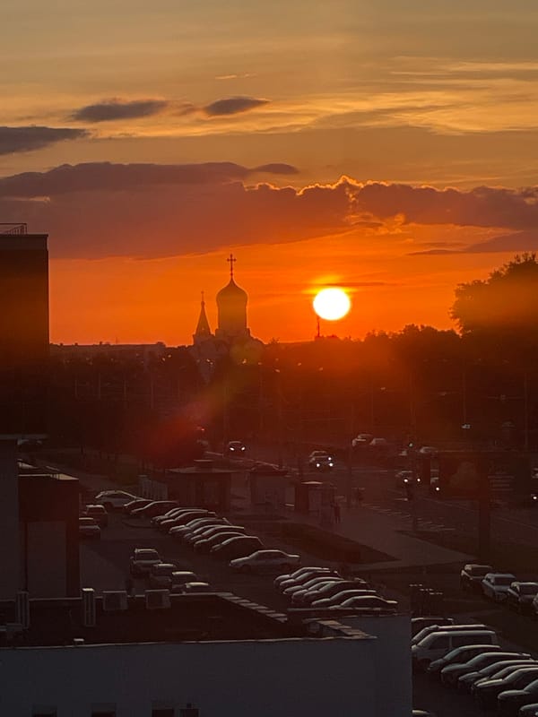 Minsk skyline caught at golden hour, sun low over the city