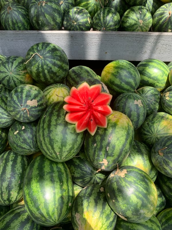 Watermelons and fresh coconuts at a Batawala market stall