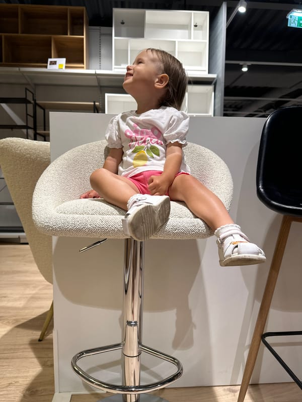 Child plays on furniture in Ustroń store, mountain views captured