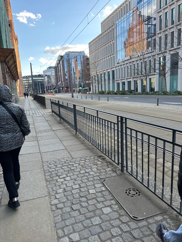 Tourists photograph famous bronze dwarf statues in central Wrocław