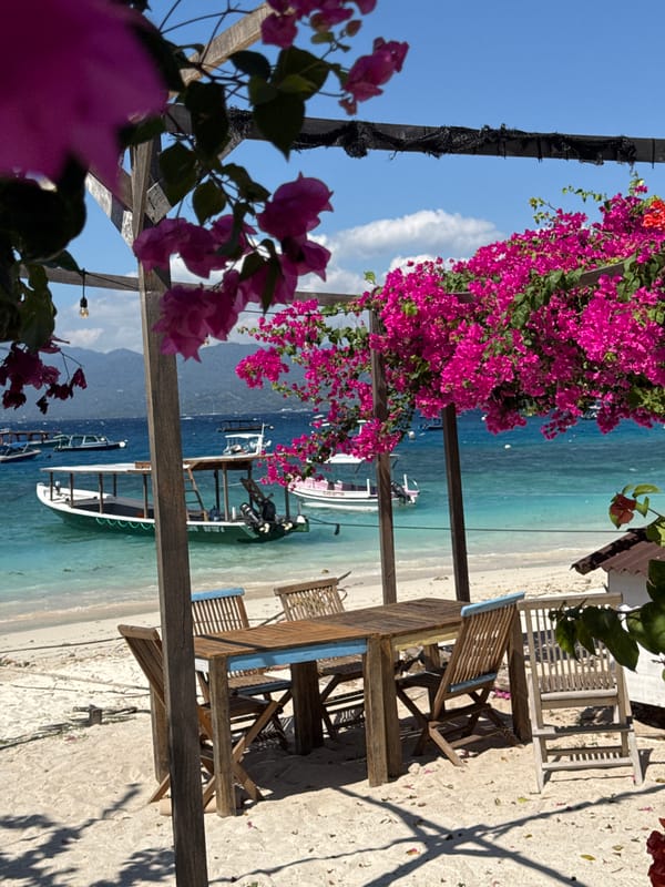 Lively Indonesian beach with cafes, horses, boats, and vendors